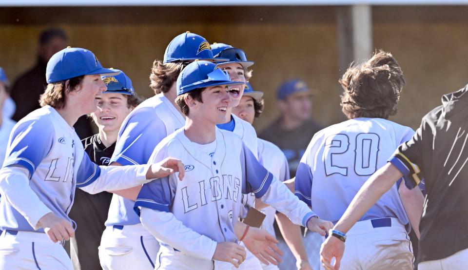 The St. John Paul II team celebrates after a three-run double by Tyler Ross on Wednesday, May 3, 2023.