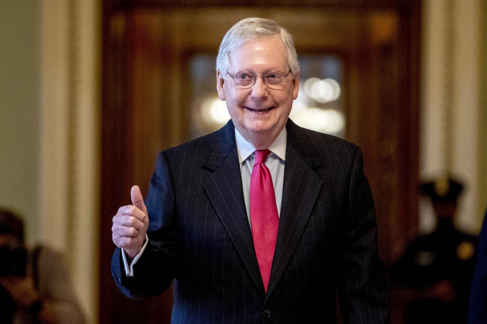 FILE - In this March 25, 2020, file photo, Senate Majority Leader Mitch McConnell, R-Ky. gives a thumbs up as he leaves the Senate chamber on Capitol Hill in Washington, where a deal has been reached on a coronavirus bill. Overwhelmed Kentucky and New York officials face a deluge of mail-in votes that are likely to delay results for days in high-profile congressional primaries on Tuesday, June 23. There's a lot of interest in two contests in particular. One involves former Marine combat pilot Amy McGrath's fight for the Democratic nomination to challenge Senate Majority Leader Mitch McConnell. (AP Photo/Andrew Harnik)