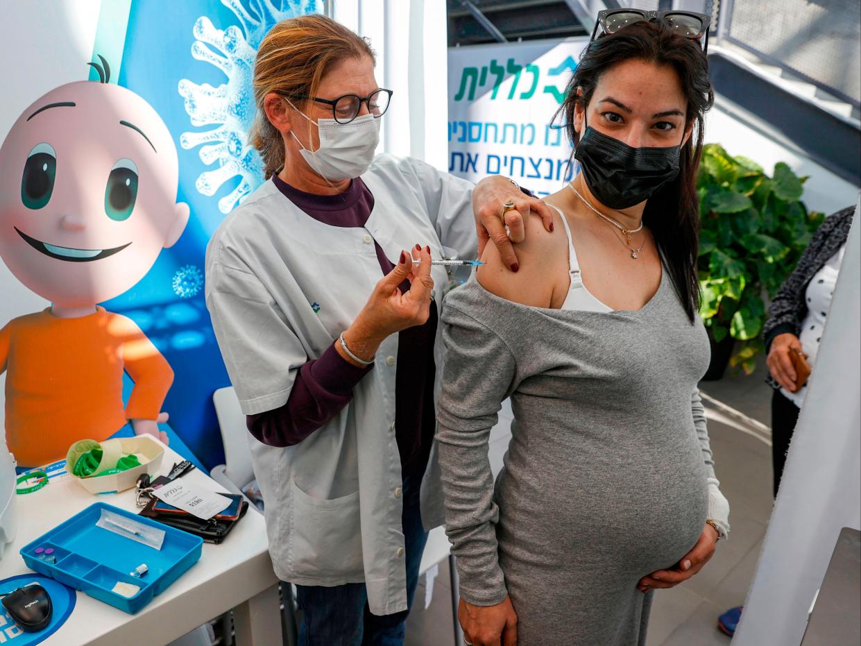 A health worker administers a dose of the Pfizer-BioNtech COVID-19 vaccine to a pregnant woman in Tel Aviv, Israel on 23 January, 2021.  (AFP via Getty Images)