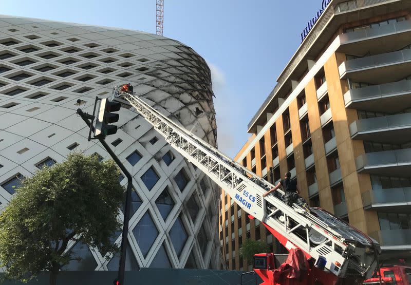 Civil defence members participate in efforts to put out a fire that broke out in a building in Central Beirut