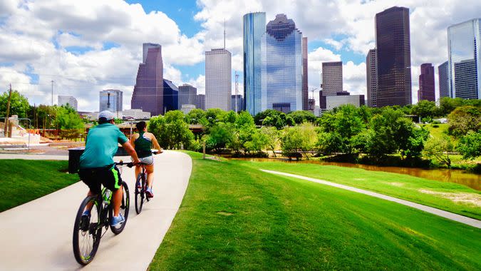 people riding along pathway in Houston Texas