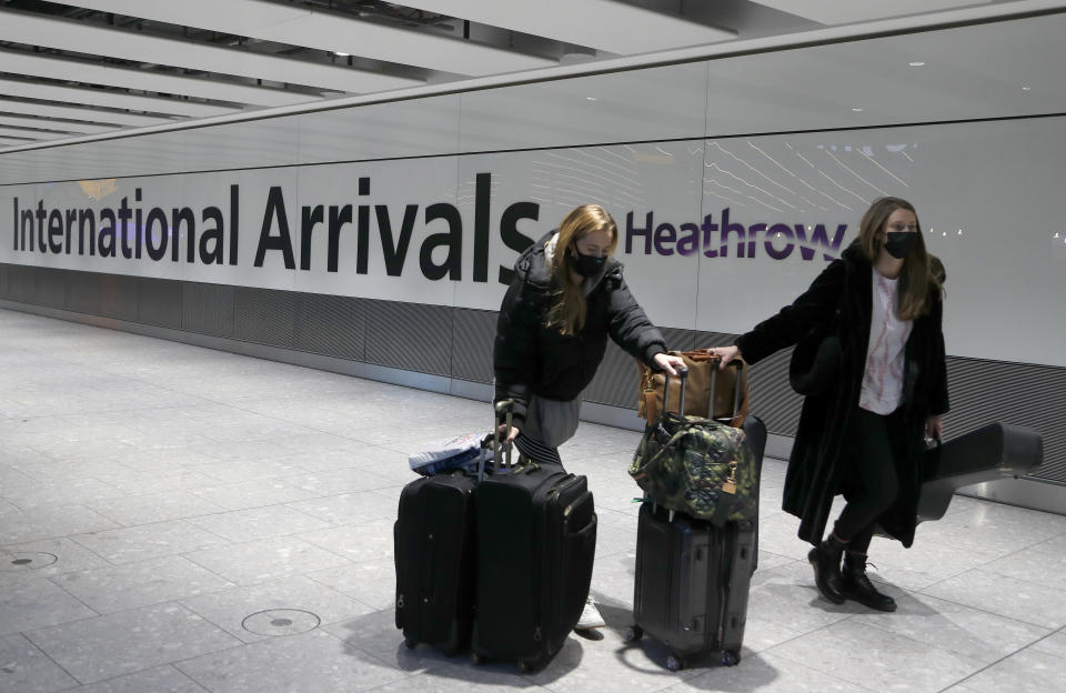 FILE - In this Jan. 17, 2021 file photo travelers arrive at Heathrow Airport in London. The U.K. has a lot to reflect on a year after British Prime Minister Boris Johnson first announced that the country would be put into a lockdown to deal with the fast-spreading coronavirus. It has seen more than 126,000 coronavirus-related deaths, more than any other in Europe and the fifth highest worldwide. (AP Photo/Frank Augstein, File)