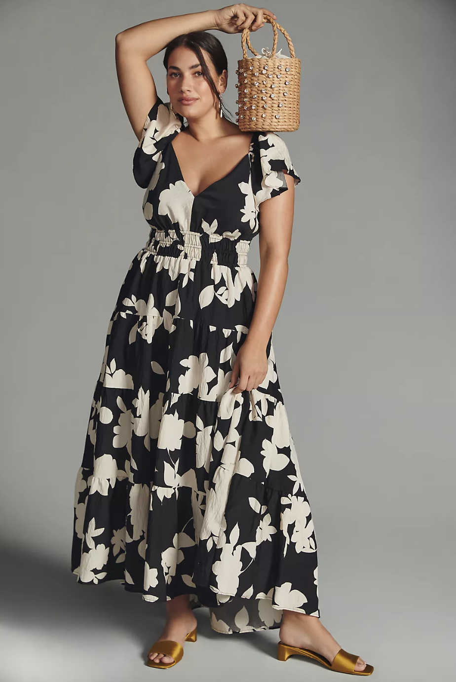 plus size model wearing black and white floral maxi dress The Silverlake Flutter-Sleeve Dress (photo via Anthropologie)