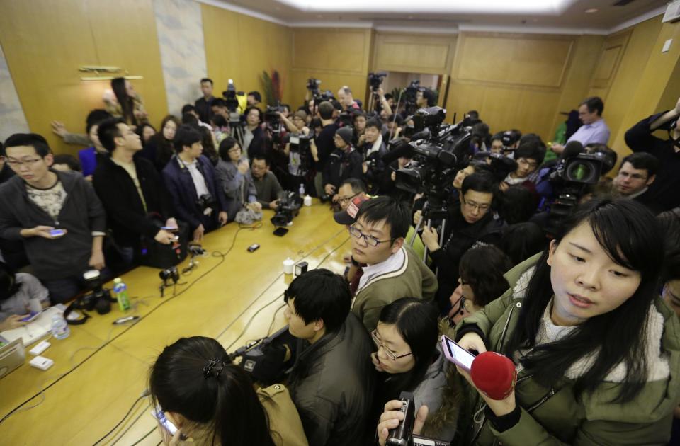 Journalists wait in a conference room for a news conference regarding the missing Malaysian Airlines flight MH370, at a hotel in Beijing