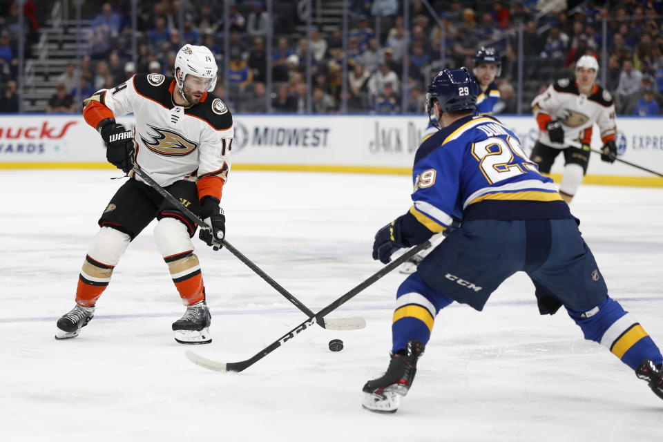 Anaheim Ducks' Adam Henrique (14) handles the puck as St. Louis Blues' Vince Dunn (29) defends during the first period of an NHL hockey game Monday, Jan. 13, 2020, in St. Louis. (AP Photo/Jeff Roberson)