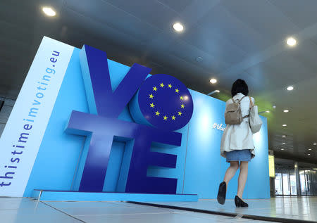 A woman walks past an advertising board for the EU elections at the Schuman railway station near the European Parliament in Brussels, Belgium, May 22, 2019. REUTERS/Yves Herman