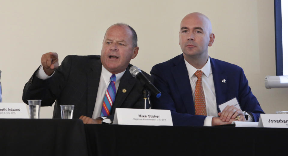 Mike Stoker regional administrator of the US EPA directs speakers as Jonathan Morrison of NHTSA looks on during the first of three public hearings on the Trump administration's proposal to roll back car-mileage standards in a region with some of the nation's worst air pollution Monday, Sept. 24, 2018 in Fresno, Calif. The day-long session by the U.S. Environmental Protection Agency and National Highway Traffic Safety Administration is a means to gather public comment concerning the mileage plan, which would freeze U.S. mileage standards at levels mandated by the Obama administration for 2020, instead of letting them rise to 36 miles per gallon by 2025. (AP Photo/Gary Kazanjian)