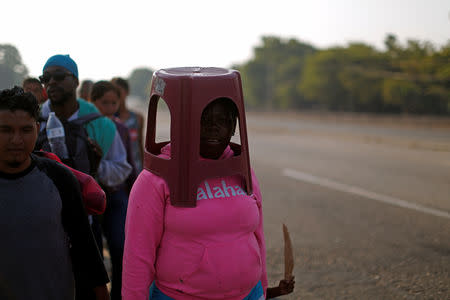 Central American migrants walk during their journey towards the United States, in Mapastepec, Mexico April 20, 2019. REUTERS/Jose Cabezas