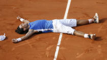 FILE - In this June 11, 2006, file photo, Spain's Rafael Nadal lays on the court after defeating Switzerland's Roger Federer in the men's final match of the the French Open tennis tournament at Roland Garros stadium in Paris. oger Federer tells The Associated Press that he figures Rafael Nadal and Novak Djokovic both will surpass his men's record for Grand Slam titles. (AP Photo/Capucine Bailly/Pool, File)