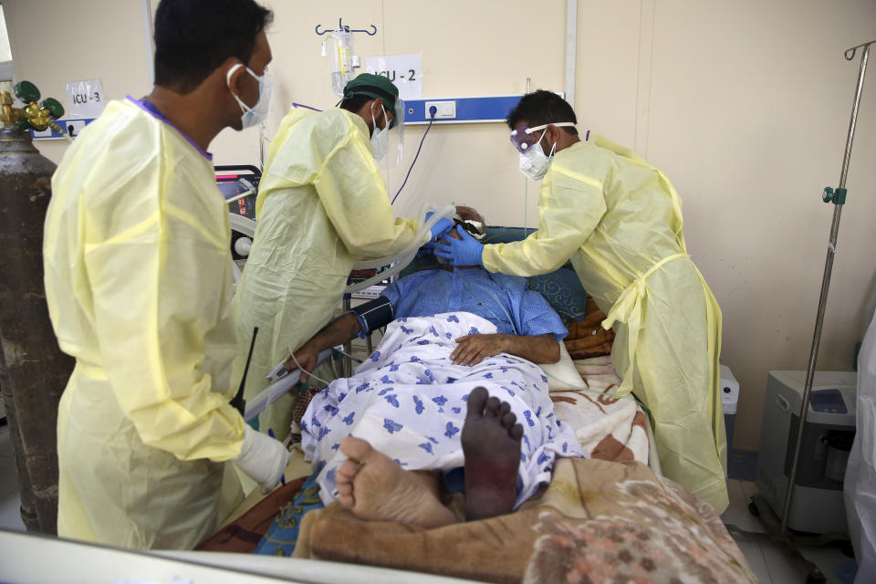 Mohammad Amin, whose left foot has turned black, is treated in the Intensive Care Unit ward for COVID-19 patients at the Afghan-Japan Communicable Disease Hospital in Kabul, Afghanistan, Tuesday June 30, 2020. (AP Photo/Rahmat Gul)