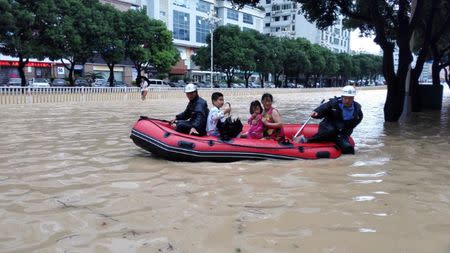 People take a boat at a flooded area as Typhoon Megi lands in Fuzhou, Fujian province, China, September 28, 2016. REUTERS/Stringer