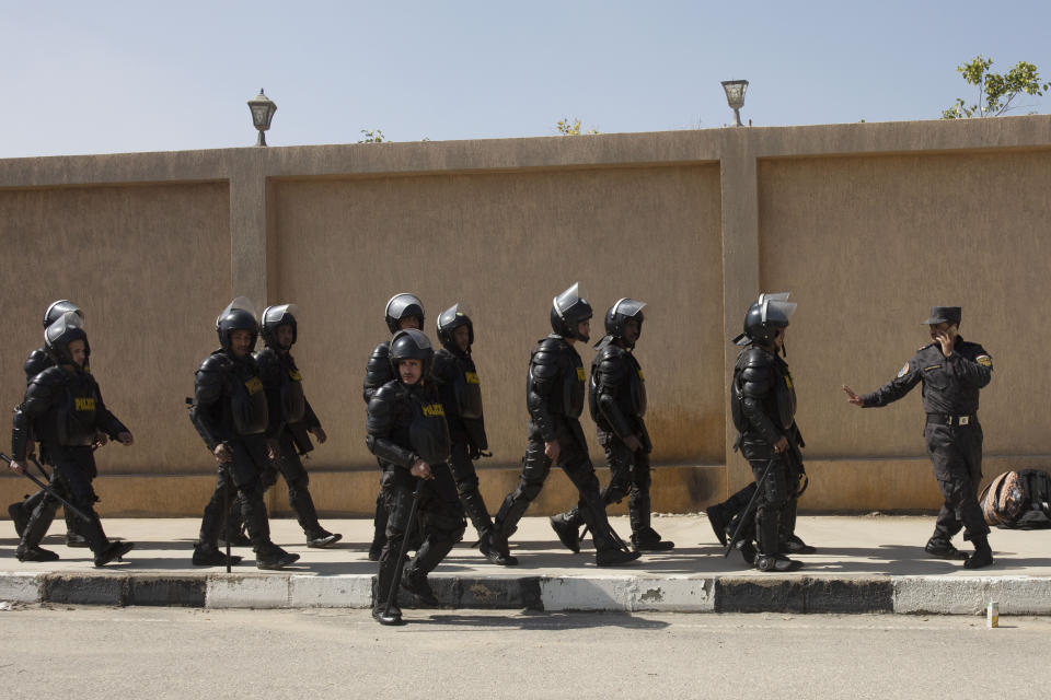 Riot policemen move into position as a few dozen supporters of ousted President Hosni Mubarak gather outside of the Tantawi Mosque before his funeral in Cairo, Egypt, Wednesday, Feb. 26, 2020. Egypt is holding a full-honors military funeral for Mubarak who was ousted from power in the 2011 Arab Spring uprising. Mubarak, 91, died Tuesday. (AP Photo/Maya Alleruzzo)