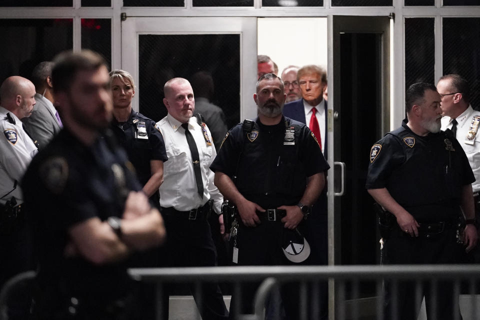 Former President Donald Trump is escorted to a courtroom, Tuesday, April 4, 2023, in New York. Trump is set to appear in a New York City courtroom on charges related to falsifying business records in a hush money investigation, the first president ever to be charged with a crime. (AP Photo/Mary Altaffer)