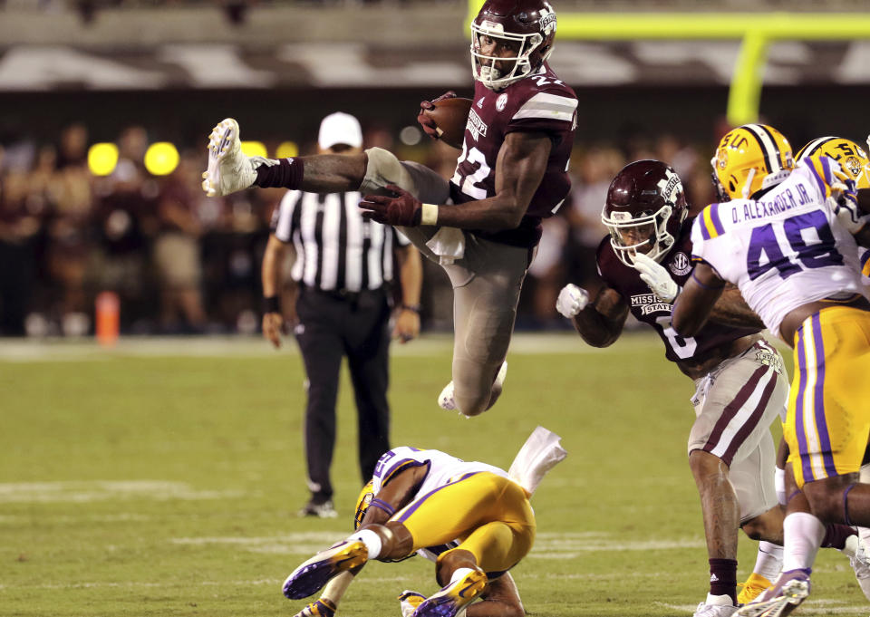 Mississippi State running back Aeris Williams (22) leaps over an LSU defender during the first half of their NCAA college football game against LSU in Starkville, Miss., Saturday, Sept. 16, 2017. Mississippi State won 37-7. (AP Photo/Jim Lyle)