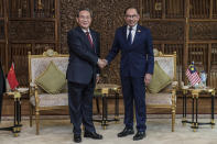 In this photo released by Malaysia's Department of Information, China's Premier Li Qiang, left, shakes hands with Malaysia Prime Minister Anwar Ibrahim before their meeting in Putrajaya, Malaysia, Wednesday, June 19, 2024. (Malaysia's Department of Information via AP)