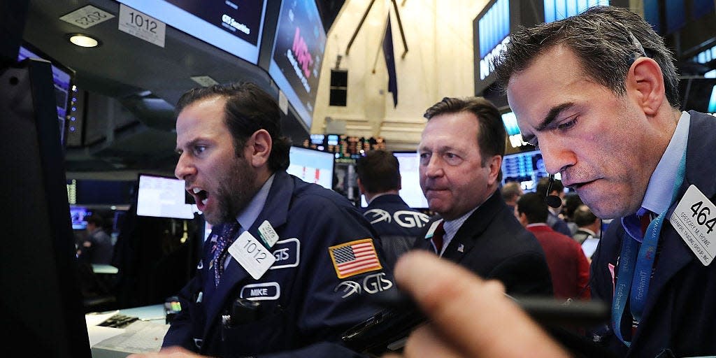 Traders work on the floor of the New York Stock Exchange