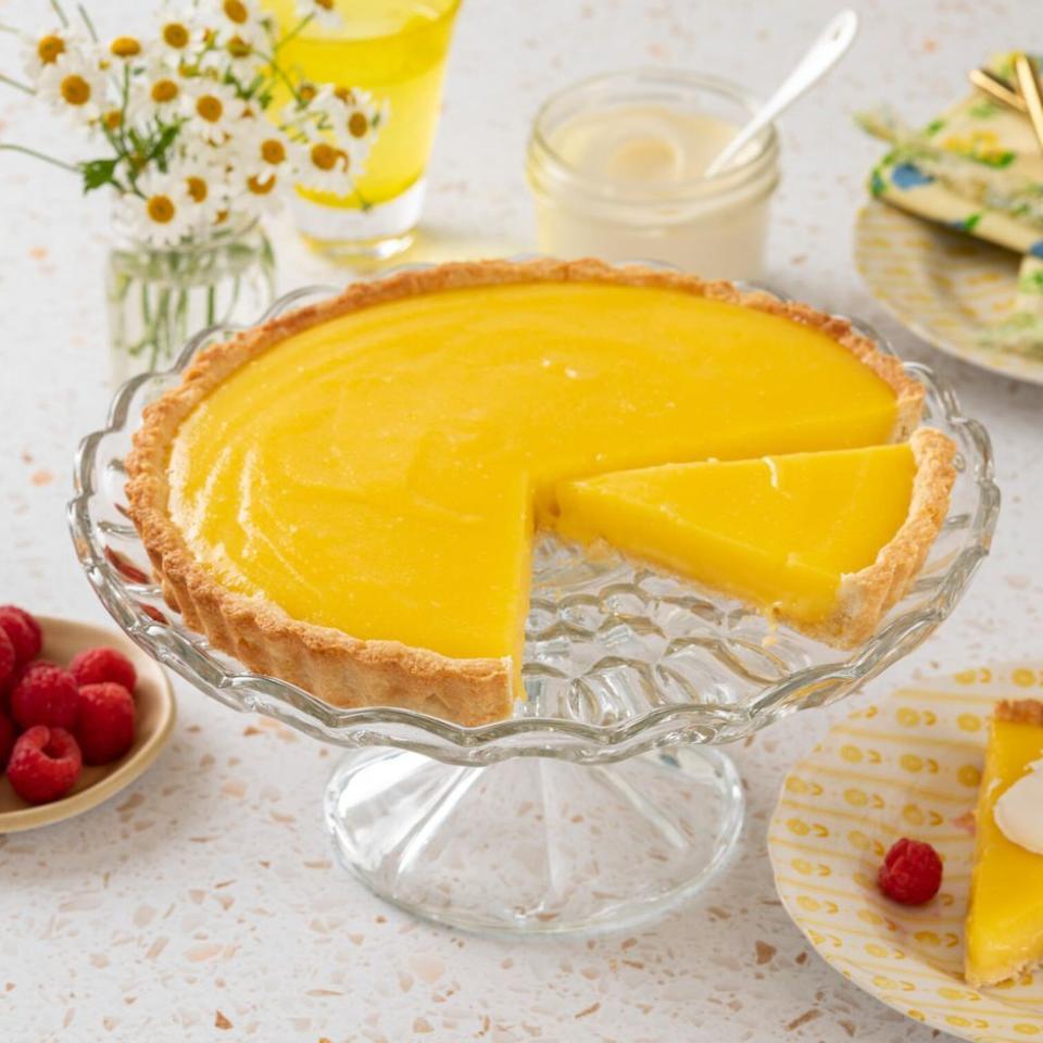 lemon tart on glass cake stand