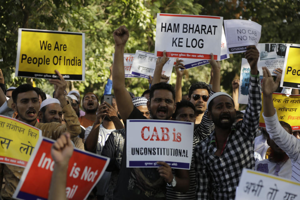 Indians holds placards and shouts slogans during a protest against Citizenship Amendment Act in Ahmadabad, India, Sunday, Dec. 15, 2019. Protests have been continuing over a new law that grants Indian citizenship based on religion and excludes Muslims. (AP Photo/Ajit Solanki)