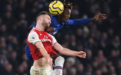 Shkodran Mustafi challenges Tammy Abraham in the air for the ball - Credit: afp
