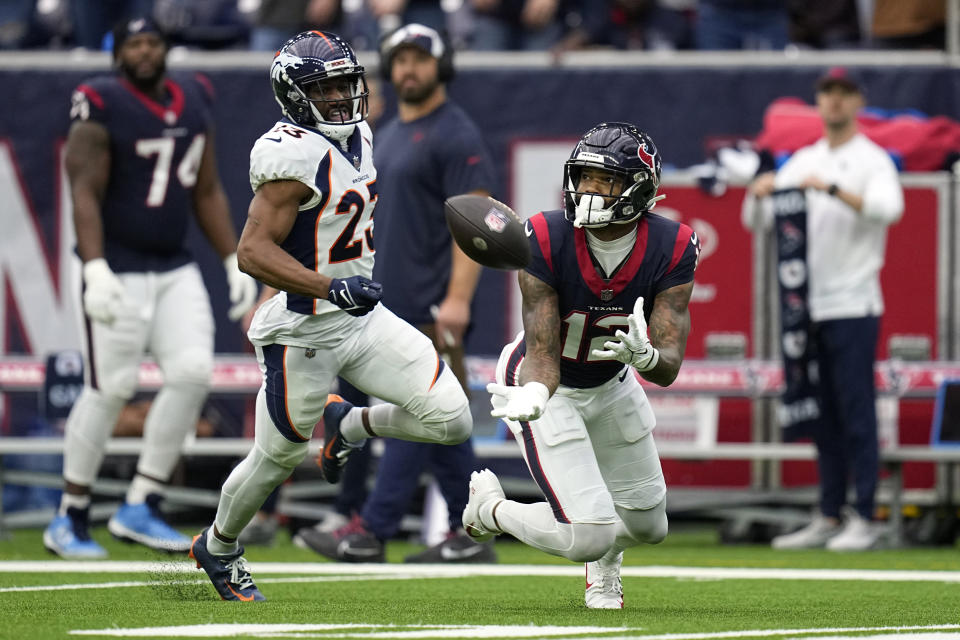 Houston Texans wide receiver Nico Collins (12) catches a pass in front of Denver Broncos cornerback Fabian Moreau (23) in the first half of an NFL football game Sunday, Dec. 3, 2023, in Houston. (AP Photo/Eric Gay)