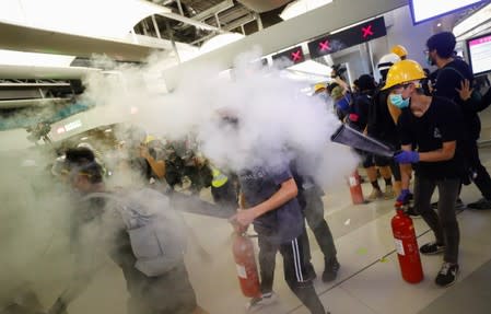 Protest at Yuen Long MTR station, the scene of an attack by suspected triad gang members a month ago, in Hong Kong