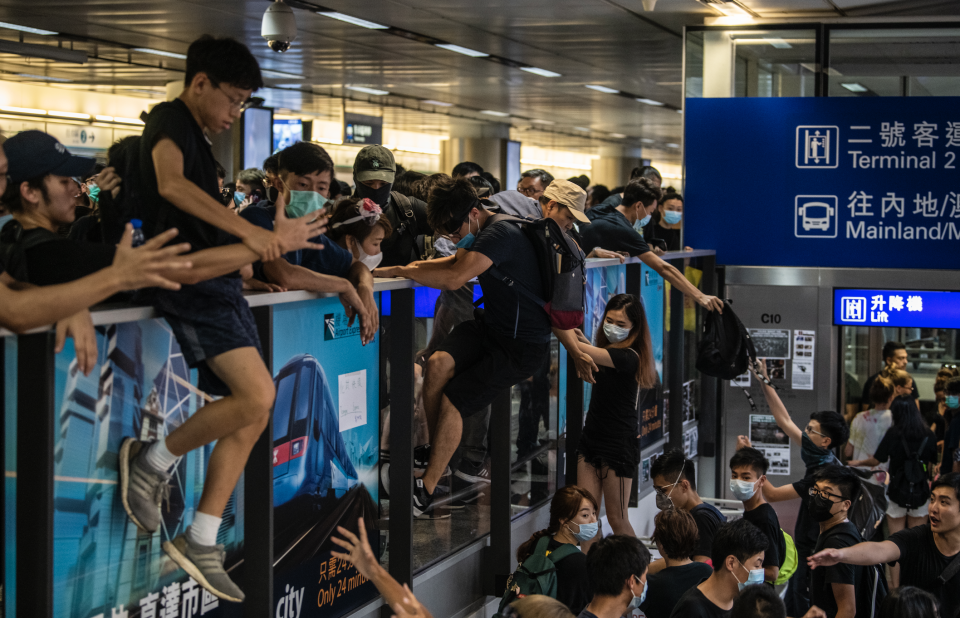 Protester are seen climbing onto the airport express station in Hong Kong International Airport in Hong Kong on August 12, 2019. (Photo: Vernon Yuen/NurPhoto via Getty Images) 