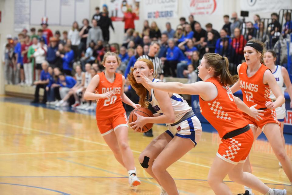 Lenawee Christian's Emerson Holsopple is boxed in by the Summerfield defense during Summerfield's 43-34 win over Lenawee Christian in the finals of the Division 4 District at Lenawee Christian on Friday, March 8, 2024.