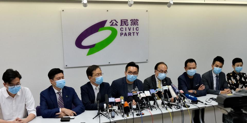 Civic Party leader Alvin Yeung (C) joins other party members during a press conference at the party headquarters in Hong Kong on July 30, 2020, after a dozen local democracy activists, including Yeung, were disqualified from standing in September's legislative elections. - A dozen Hong Kong democracy activists were disqualified on July 30 from standing in September's legislative elections, a move decried by candidates as the most pressing assault yet on Beijing's critics in the city. (Photo by Anthony WALLACE / AFP) (Photo by ANTHONY WALLACE/AFP via Getty Images)