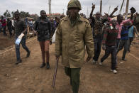 <p>Protestors yell for peace as they march behind a Kenyan police officer in the Kawangware slum, on August 10, 2017 in Nairobi, Kenya. Tensions remain high as rumors of election fraud surround the presidential election between incumbent president Uhuru Kenyatta and his rival Raila Odinga. (Photo: Andrew Renneisen/Getty Images) </p>