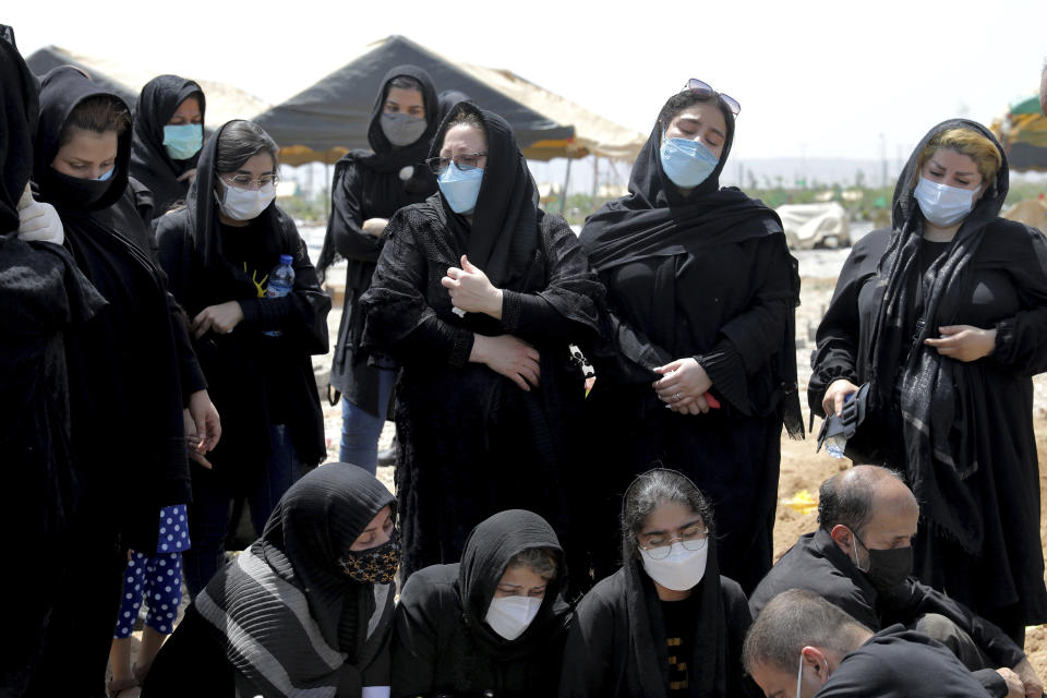 Mourners attend the funeral of a person who died from COVID-19, at the Behesht-e-Zahra cemetery just outside Tehran, Iran, Wednesday, April 21, 2021. After facing criticism for downplaying the virus last year, authorities have put partial lockdowns and other measures in place to try and slow the coronavirus’ spread, as Iran faces what looks like its worst wave of the coronavirus pandemic yet. (AP Photo/Ebrahim Noroozi)