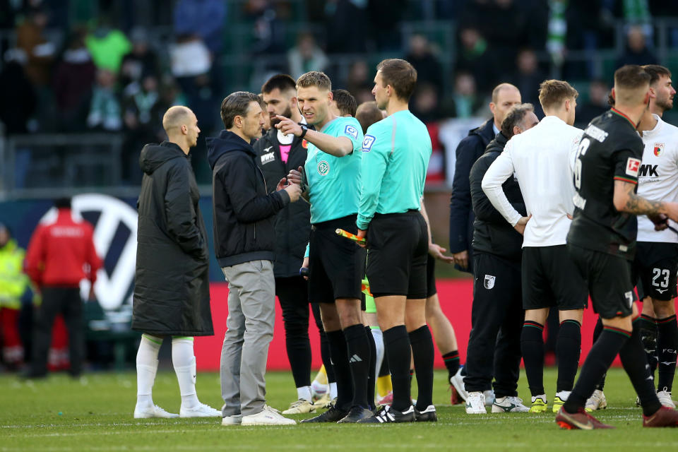 WOLFSBURG, GERMANY - MARCH 16: Niko Kovac, Head Coach of VfL Wolfsburg, speaks with Referee Timo Gerach after the Bundesliga match between VfL Wolfsburg and FC Augsburg at Volkswagen Arena on March 16, 2024 in Wolfsburg, Germany. (Photo by Cathrin Mueller/Getty Images)