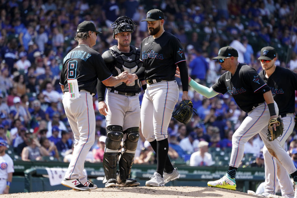 Miami Marlins manager Don Mattingly (8) pulls starting pitcher Pablo Lopez, center, after Lopez gave up a home run to Chicago Cubs' P.J. Higgins during the sixth inning of a baseball game Saturday, Aug. 6, 2022, in Chicago. (AP Photo/Charles Rex Arbogast)