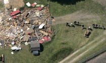 FILE - In this May 24, 2006, file photo, workers, including Federal Bureau of Investigation evidence response team members, probe the ground near a demolished barn at a horse farm in Milford Township, Mich., where FBI agents investigating Jimmy Hoffa's 1975 disappearance. The FBI's recent confirmation that it was looking at a spot near a New Jersey landfill as the possible burial site of former Teamsters boss Jimmy Hoffa is the latest development in a search that began when he disappeared. (AP Photo/Paul Sancya, File)