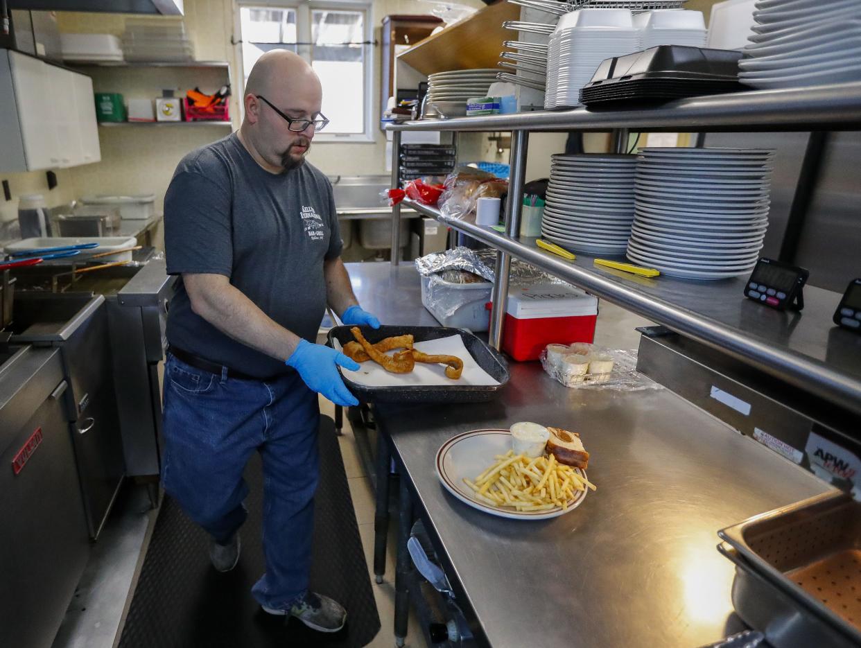 Co-owner and chef James Greve prepares a fish fry order on Feb. 17 at Kellner International Bar in Kellner.