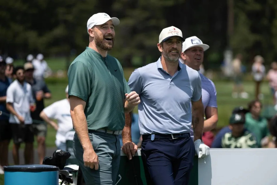 Kansas City Chiefs player Travis Kelce, left, and New York Jets quarterback Aaron Rodgers chat near the 7th tee in the first round of the American Century celebrity golf championship on Friday, July 12, 2024, in Stateline, Nev.