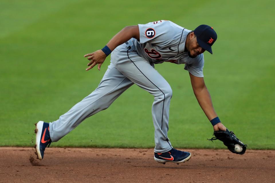 Tigers third baseman Jeimer Candelario fields the ball before throwing out Reds third baseman Eugenio Suarez in the third inning at Great American Ballpark in Cincinnati, Friday, July 24, 2020.