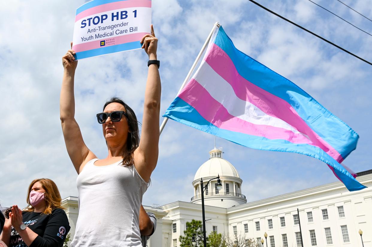 A protestor holds a sign during a rally outside the Alabama State House in March 2021.