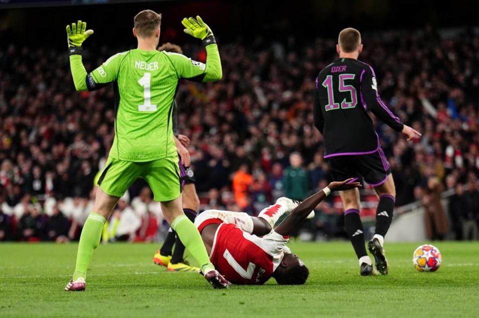 No penalty: Bukayo Saka was brought down by a last-gasp foul from Manuel Neuer (John Walton/PA Wire)