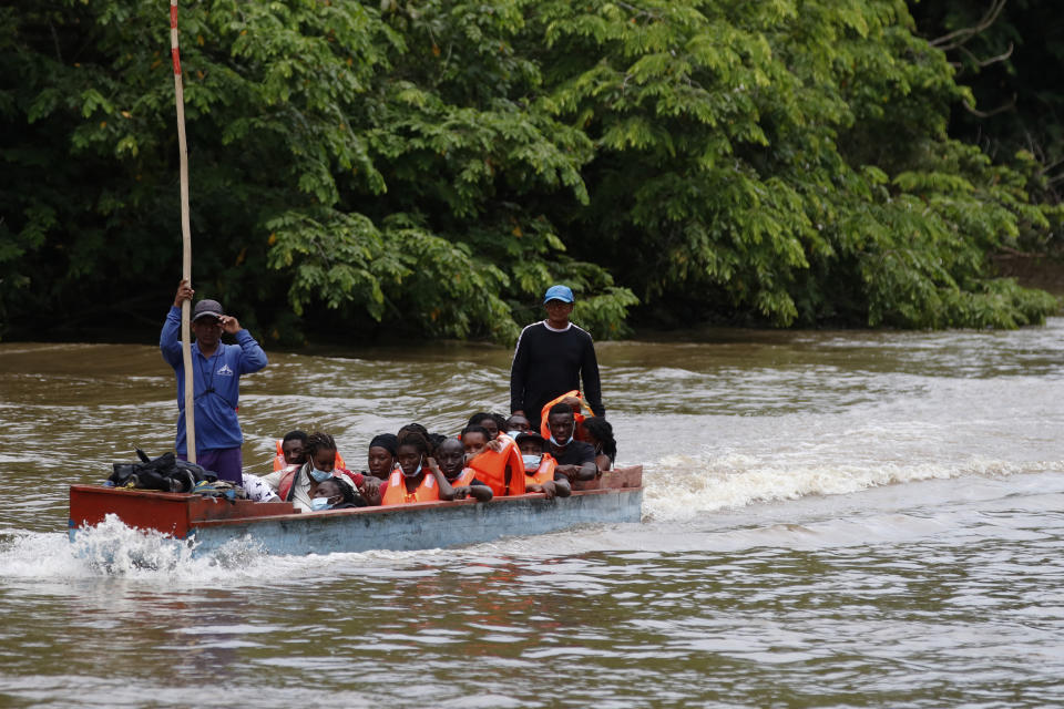 Migrants arrive via a boat in Lajas Blancas, Darien, Panama, Saturday, Oct. 23, 2021. A rising number of female migrants have reported suffering sexual abuse while crossing the treacherous Darien Gap between Colombia and Panama. Seeking to draw attention to the issue, a group of Panamanian lawmakers travelled Saturday on a fact-finding mission to speak with victims and authorities in the remote province. (AP Photo/Ana Renteria)