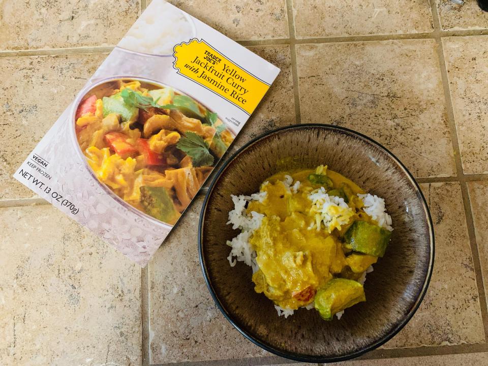 Trader Joe's box of jackfruit curry beside bowl with cooked entree