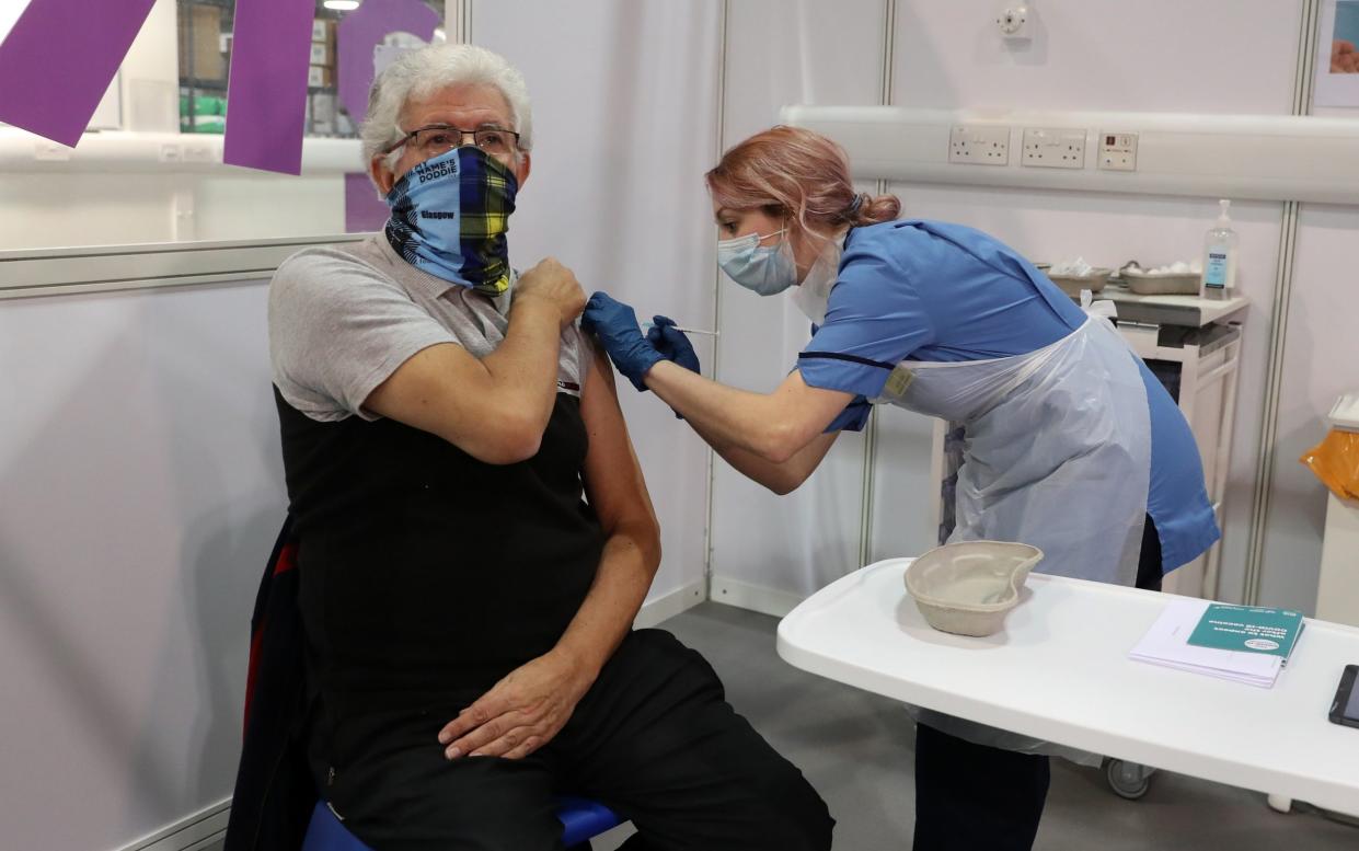 69-year-old John Loch from Glasgow receives his first dose of the vaccine from nurse Nicole Clark at the NHS Louisa Jordan Hospital last week - Getty Images Europe