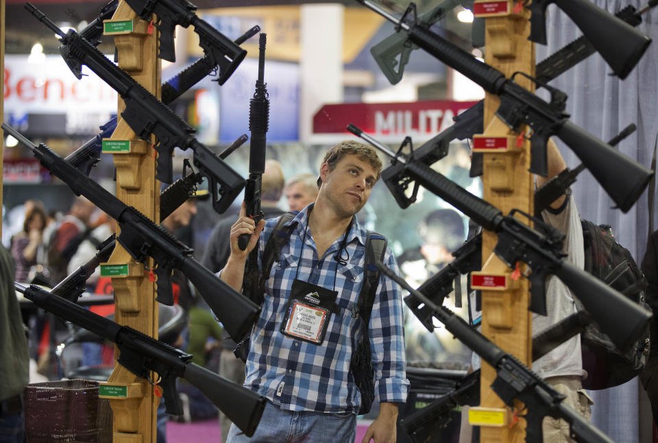 A display of rifles at the Rock River Arms booth during the 35th annual SHOT Show in Las Vegas. The largest gun industry trade show will be taking place in Las Vegas Jan. 23-26 just a few miles from where a gunman carried out the deadliest mass shooting in modern U.S. history. (AP Photo/Julie Jacobson, File)