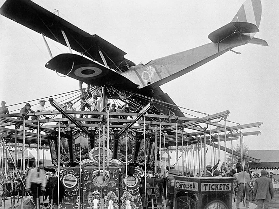 Fred McCall crash-landed his Curtiss Jenny on top of a rotating merry-go-round at the Calgary Exhibition in 1919, after his engine stalled shortly after takeoff. (Courtesy of Glenbow Library and Archives, Libraries and Cultural Resources Digital Collections, University of Calgary - image credit)