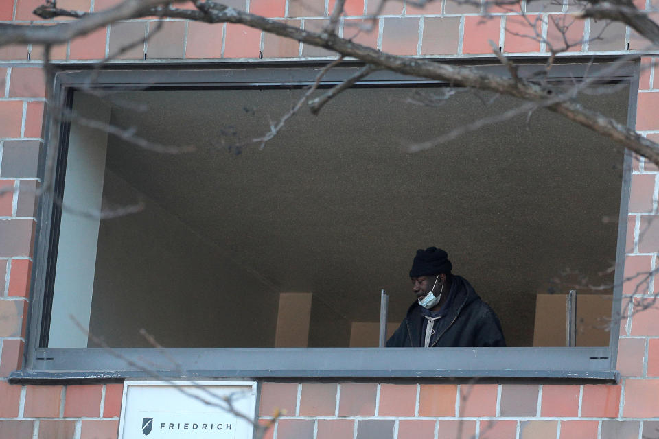 Image: A resident is seen inside his apartment after returning to the scene of a fire at a multi-level apartment building in the Bronx borough of New York (Brendan McDermid / Reuters)