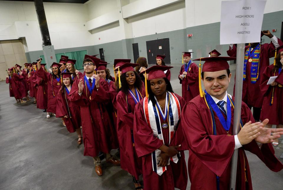 Graduates from Doherty Memorial High School line up for commencement exercises at the DCU Center Tuesday evening.