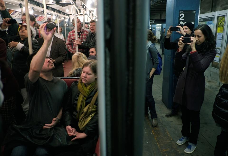 NEW YORK, NY - DECEMBER 16: People take pictures of a vintage New York City subway car as it sits in the 2nd Ave. station on December 16, 2012 in New York City. The New York Metropolitan Transportation Authority (MTA) runs vintage subway trains from the 1930's-1970's each Sunday along the M train route from Manhattan to Queens through the first of the year. (Photo by Preston Rescigno/Getty Images)