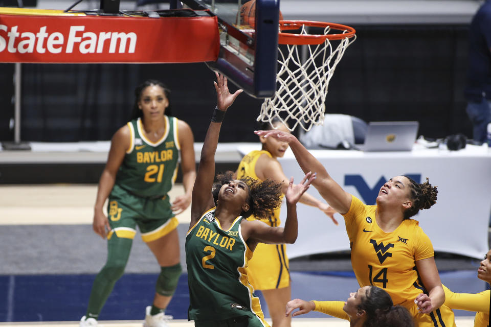 Baylor guard DiDi Richards (2) shoots while defended by West Virginia forward Kari Niblack (14) during the second half of an NCAA college basketball game Thursday, Dec. 10, 2020, in Morgantown, W.Va. (AP Photo/Kathleen Batten)