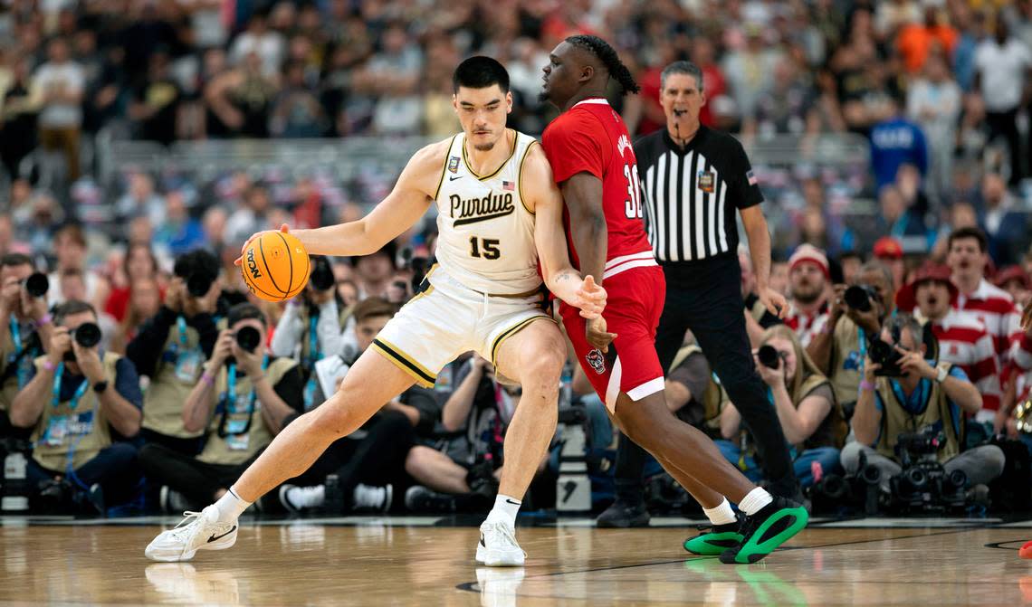 Purdue’s Zach Edey (15) post up against N.C. State’s D.J. Burns Jr. (30) during the first half in the NCAA Final Four National Semifinal game on Saturday, April 6, 2024 at State Farm Stadium in Glendale, AZ. Robert Willett/rwillett@newsobserver.com