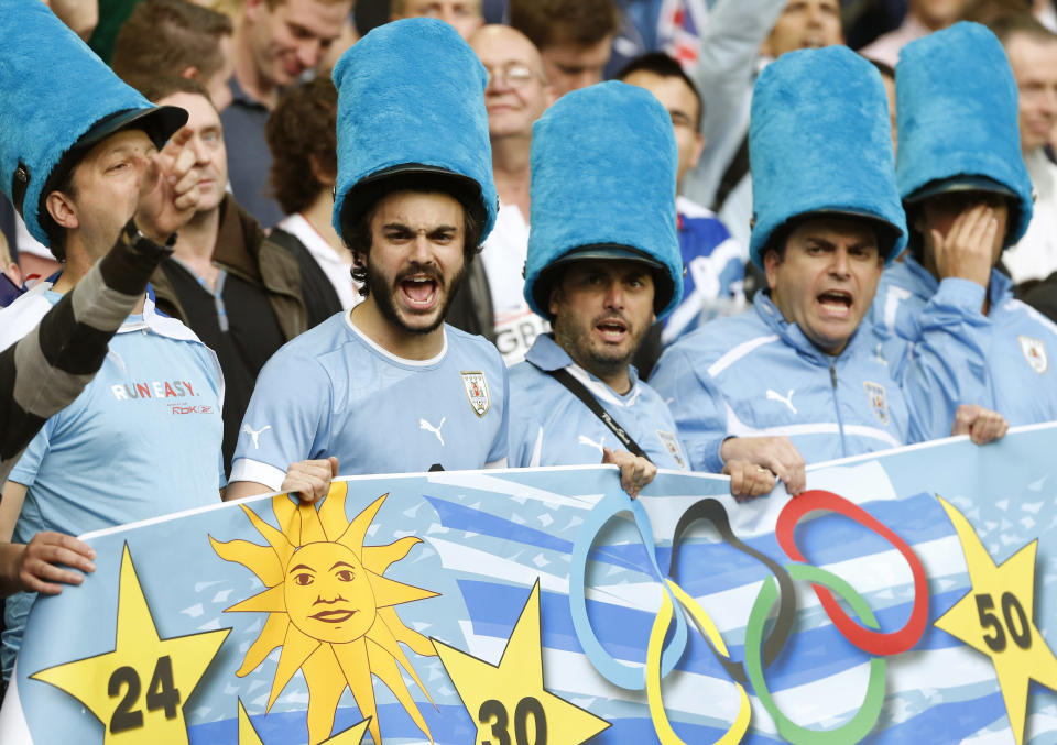 Uruguay fans in costume sing before the Britain - Uruguay match in men's Group A football at the London 2012 Olympic Games at Millennium Stadium in Cardiff August 1, 2012. REUTERS/Francois Lenoir (BRITAIN - Tags: SPORT SOCCER SPORT OLYMPICS) 