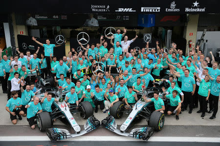 Formula One F1 - Brazilian Grand Prix - Autodromo Jose Carlos Pace, Interlagos, Sao Paulo, Brazil - November 11, 2018 Mercedes' Lewis Hamilton, Mercedes' Valtteri Bottas, Executive Director Toto Wolff and team members pose after winning the constructors championship REUTERS/Paulo Whitaker